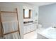 Bright bathroom with modern fixtures, a tub, vanity and white and blue walls at 360 Darren Dr, Fayetteville, GA 30215