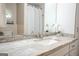 Bright bathroom featuring a marble countertop, white cabinets, and a decorative mirror, offering a clean and stylish space at 360 Darren Dr, Fayetteville, GA 30215