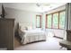 Bright main bedroom with a large window, cozy furniture, and neutral decor at 360 Darren Dr, Fayetteville, GA 30215