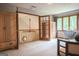 Bright bedroom showcasing french doors to loft and two large wooden armoires at 360 Darren Dr, Fayetteville, GA 30215
