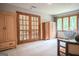 Spacious bedroom featuring beautiful french doors and two large wooden armoires at 360 Darren Dr, Fayetteville, GA 30215