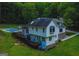 Rear exterior view of home featuring a wooden deck overlooking a swimming pool and a lush lawn at 360 Darren Dr, Fayetteville, GA 30215