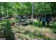 Fire pit surrounded by seating in a wooded area, perfect for relaxing and entertaining outdoors in nature at 360 Darren Dr, Fayetteville, GA 30215
