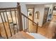 Elegant hardwood staircase with view of open concept kitchen and modern island at 360 Darren Dr, Fayetteville, GA 30215