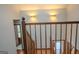 Wooden staircase with decorative wall sconces and an open view of downstairs at 360 Darren Dr, Fayetteville, GA 30215
