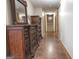 Hallway with a large dresser, mirror, and unique flooring, creating a functional and stylish transition space at 360 Darren Dr, Fayetteville, GA 30215