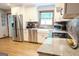 Bright kitchen with stainless steel appliances, white cabinets, granite countertops, and hardwood floors at 360 Darren Dr, Fayetteville, GA 30215