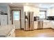 Bright kitchen with stainless steel appliances, white cabinets, granite countertops, and hardwood floors at 360 Darren Dr, Fayetteville, GA 30215