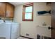 Functional laundry room with washer, dryer, utility sink and a window to provide natural light at 360 Darren Dr, Fayetteville, GA 30215