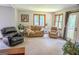 Cozy living room with large windows, carpet, and comfortable seating arrangement at 360 Darren Dr, Fayetteville, GA 30215
