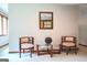 Cozy living room with decorative chairs, glass table, and elegant decorative mirror at 360 Darren Dr, Fayetteville, GA 30215