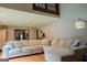 Bright living room featuring a large L shaped couch, hardwood floors and abundant natural light at 360 Darren Dr, Fayetteville, GA 30215
