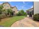 Backyard with a stone patio, green lawn, a black iron fence, landscaping, and the sunroom addition at 416 Fairway Dr, Acworth, GA 30101