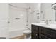 Clean bathroom with a shower-tub combo, dark wood vanity, and neutral tile floors at 416 Fairway Dr, Acworth, GA 30101