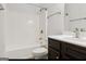 Bathroom featuring a shower and bath combo, a modern sink with brown cabinets, and stylish fixtures at 416 Fairway Dr, Acworth, GA 30101