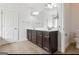 Bright bathroom featuring a double vanity with dark wood cabinets and tile floors at 416 Fairway Dr, Acworth, GA 30101