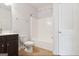 Bathroom with a toilet, shower and tub and a vanity with dark cabinets at 416 Fairway Dr, Acworth, GA 30101