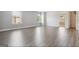 Bright bedroom with gray walls, hardwood floors, two windows, and a doorway to another room at 416 Fairway Dr, Acworth, GA 30101