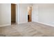 Bedroom with neutral carpet, base molding, and two doorways to a closet and bathroom at 416 Fairway Dr, Acworth, GA 30101