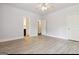 Spacious bedroom with light wood floors, white walls, and entryways to an en-suite and hallway at 416 Fairway Dr, Acworth, GA 30101