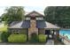 Exterior view of the community clubhouse with stone chimney and community pool adjacent at 416 Fairway Dr, Acworth, GA 30101