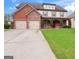 Two-story home with a brick and stone exterior, well-manicured lawn, and a two-car garage at 416 Fairway Dr, Acworth, GA 30101