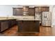 Well-equipped kitchen with island, granite counters, dark cabinets and stainless steel appliances at 416 Fairway Dr, Acworth, GA 30101