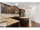Kitchen featuring granite countertops, stainless steel appliances, island and dark wood cabinets at 416 Fairway Dr, Acworth, GA 30101