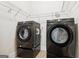 Functional laundry room equipped with modern washer and dryer appliances, and wire shelving at 416 Fairway Dr, Acworth, GA 30101
