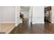 Open-concept living room with hardwood floors, white trim, and view of kitchen at 416 Fairway Dr, Acworth, GA 30101