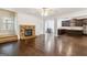 Open living room with stone fireplace, hardwood floors, and view of kitchen and dining area at 416 Fairway Dr, Acworth, GA 30101