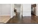 Open-concept living room with hardwood floors, white trim, and stainless steel appliances at 416 Fairway Dr, Acworth, GA 30101