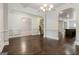 Spacious living room featuring hardwood floors, white trim, and elegant chandelier at 416 Fairway Dr, Acworth, GA 30101