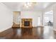 Spacious living room featuring hardwood floors, stone fireplace, and access to backyard at 416 Fairway Dr, Acworth, GA 30101