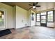 Enclosed sunroom with neutral walls, tile floors, windows, a ceiling fan, and an exterior door at 416 Fairway Dr, Acworth, GA 30101