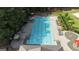 Aerial view of community swimming pool with lounge chairs, pool umbrellas, and splash pad at 416 Fairway Dr, Acworth, GA 30101