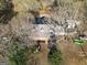 An aerial view of a charming home with dormer windows surrounded by mature trees and lush greenery at 75 Price W Dr, Locust Grove, GA 30248