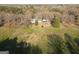 A picturesque aerial view of a home, showcasing its expansive yard and proximity to mature trees at 75 Price W Dr, Locust Grove, GA 30248