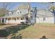 Inviting single-story home featuring a charming front porch, dormer windows, and beautifully maintained lawn at 75 Price W Dr, Locust Grove, GA 30248