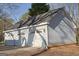 Spacious three-car garage with ample storage space and classic carriage-style doors to enhance curb appeal at 75 Price W Dr, Locust Grove, GA 30248