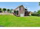 Backyard view of a brick home, featuring a garage, elevated wooden deck, and lush green lawn at 186 Ashley Dr, Mcdonough, GA 30252