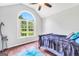 Light-filled bedroom with vaulted ceiling, large window, ceiling fan, and hardwood flooring at 186 Ashley Dr, Mcdonough, GA 30252
