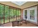 A screened porch with brick walls and seating that overlooks a wooded area at 186 Ashley Dr, Mcdonough, GA 30252