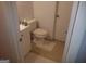 Compact bathroom featuring a toilet and sink with a light-colored vanity at 3248 Brisbane Way, Lithonia, GA 30038