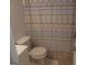 Compact bathroom featuring a toilet and sink with a patterned shower curtain at 3248 Brisbane Way, Lithonia, GA 30038