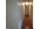 Hallway with wood flooring, white walls, and closet space at 3248 Brisbane Way, Lithonia, GA 30038