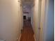 Hallway with wood floors and a view of the living room featuring a fireplace at 3248 Brisbane Way, Lithonia, GA 30038