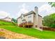 Expansive backyard view showcasing a wooden deck, patio, well-maintained lawn, and exterior architecture at 4311 Hampton Mill Pkwy, Douglasville, GA 30135