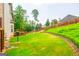 Sprawling backyard featuring a lush lawn, a privacy fence, and mature trees for added seclusion at 4311 Hampton Mill Pkwy, Douglasville, GA 30135