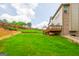 Spacious backyard with a lush green lawn, wooden deck, and a privacy fence at 4311 Hampton Mill Pkwy, Douglasville, GA 30135